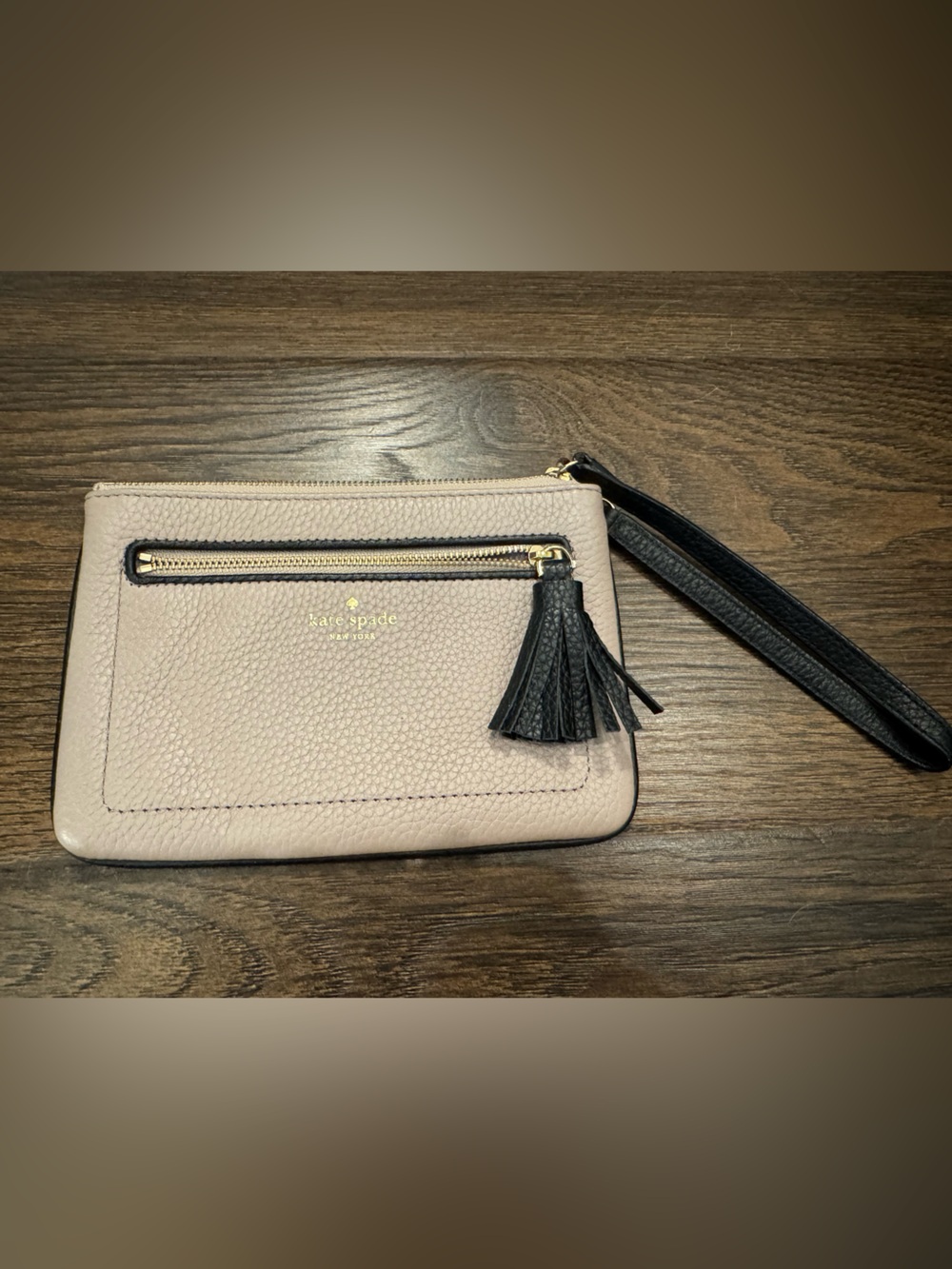 kate spade beige pebbled leather wristlet with black tassel